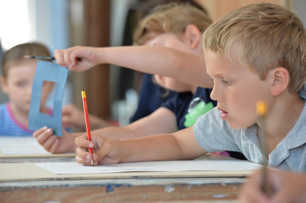 boys drawing in kids art class