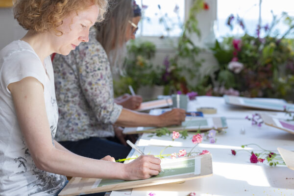 Studio picture of students painting flowers at the st ives school of painting