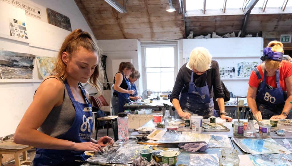 Students painting at an art school