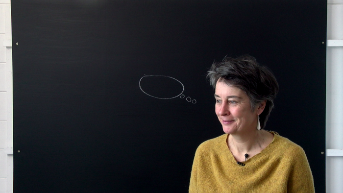 Artist Alice Mumford at a blackboard as she leads free Free Online Art Discussion